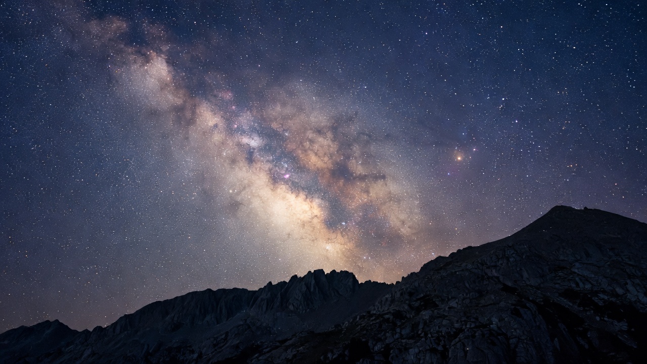 The Milky Way over a dark mountain ridge